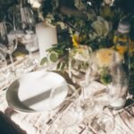 Beautiful table set for some festive event, party or wedding reception on the sunset