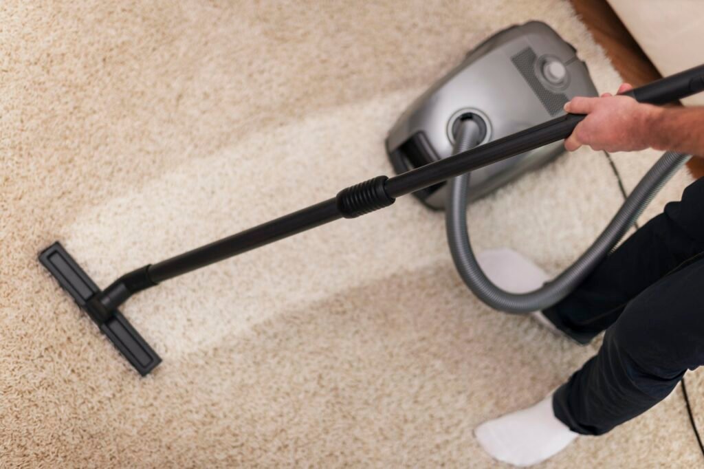 Close up of vacuuming a carpet — The Design Tourist