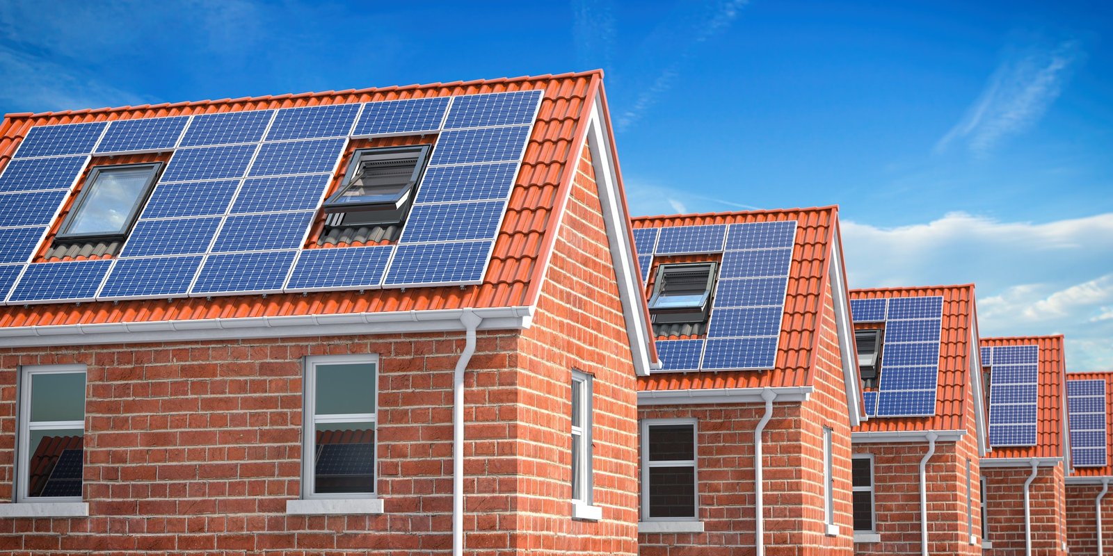Row of house with solar panels on roof on blue sky background. — The