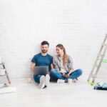 Young couple using laptop during home improvement