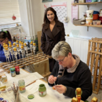 Lauscha Germany Marolin artist handpainting the paper mache figurines.