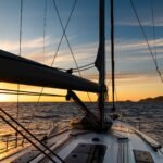 Yacht sailing at sunset during a storm. Luxury vacation at sea