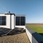 Woman on the roof of her house with a solar station