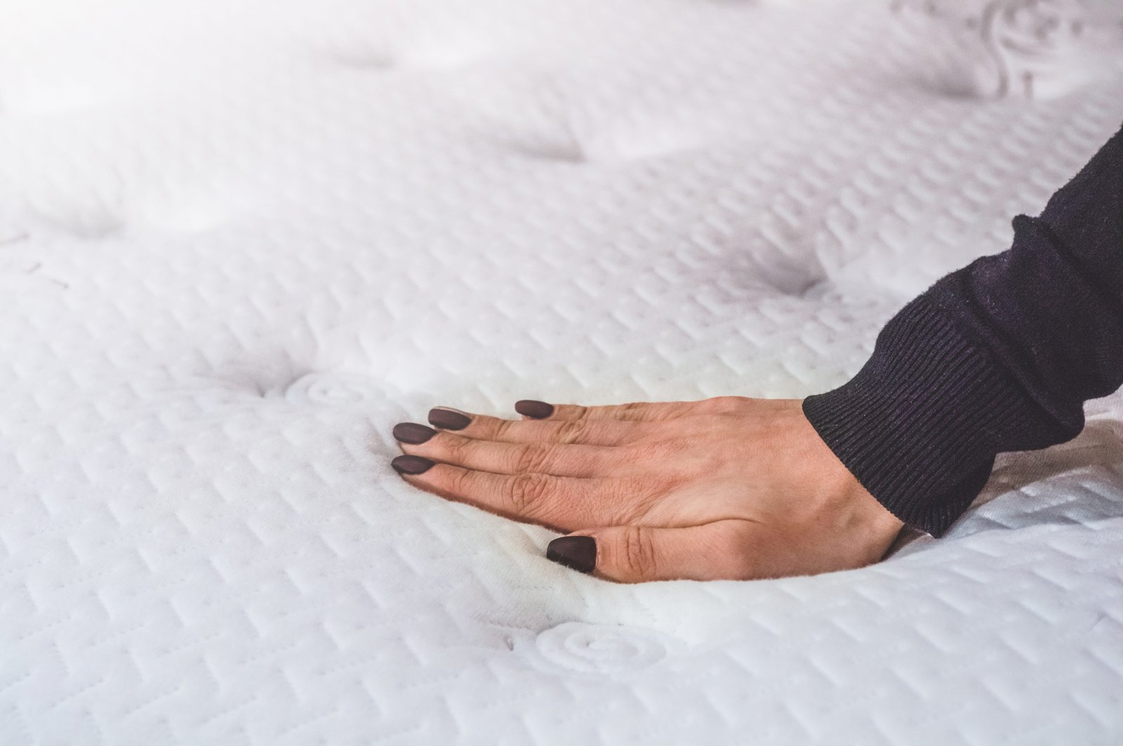 Girl touches the mattress.