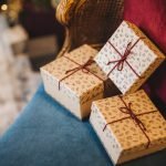 Holiday event essentials, celebration and surprise concept. Boxes of gifts lie on grand armchair, waits for host.