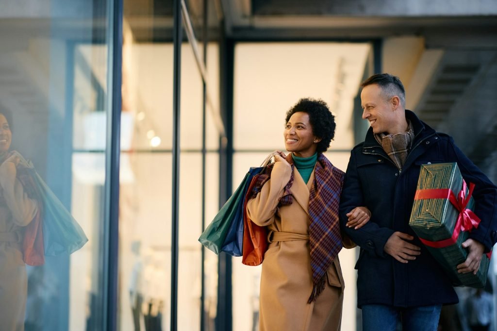 Happy couple window shopping during Christmas holidays.