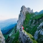 Tourist on the high rocks background. Sport and active life concept. Adventure and travel