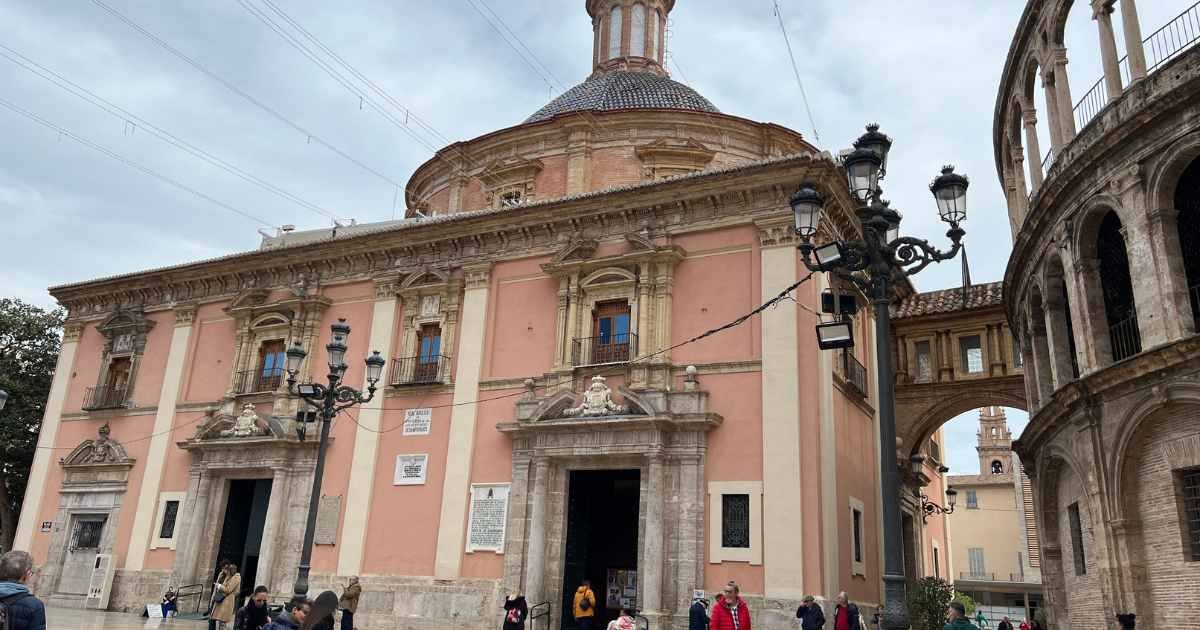 Basilica Senora Desamparados building with a dome and people walking around