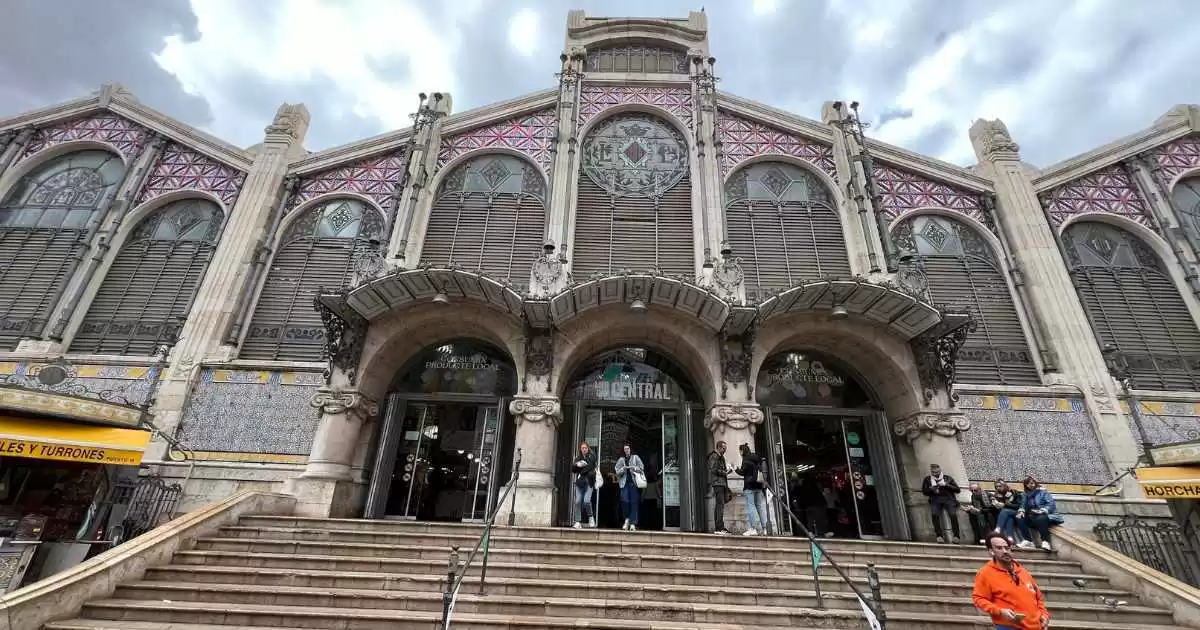 Central market building exterior view with many windows and stairs,