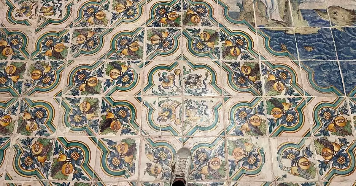 a person's foot on a tile floor