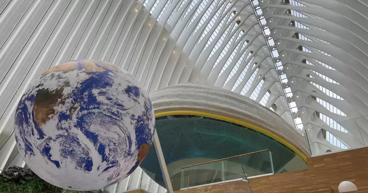 a large globe in a Caixa Forum building