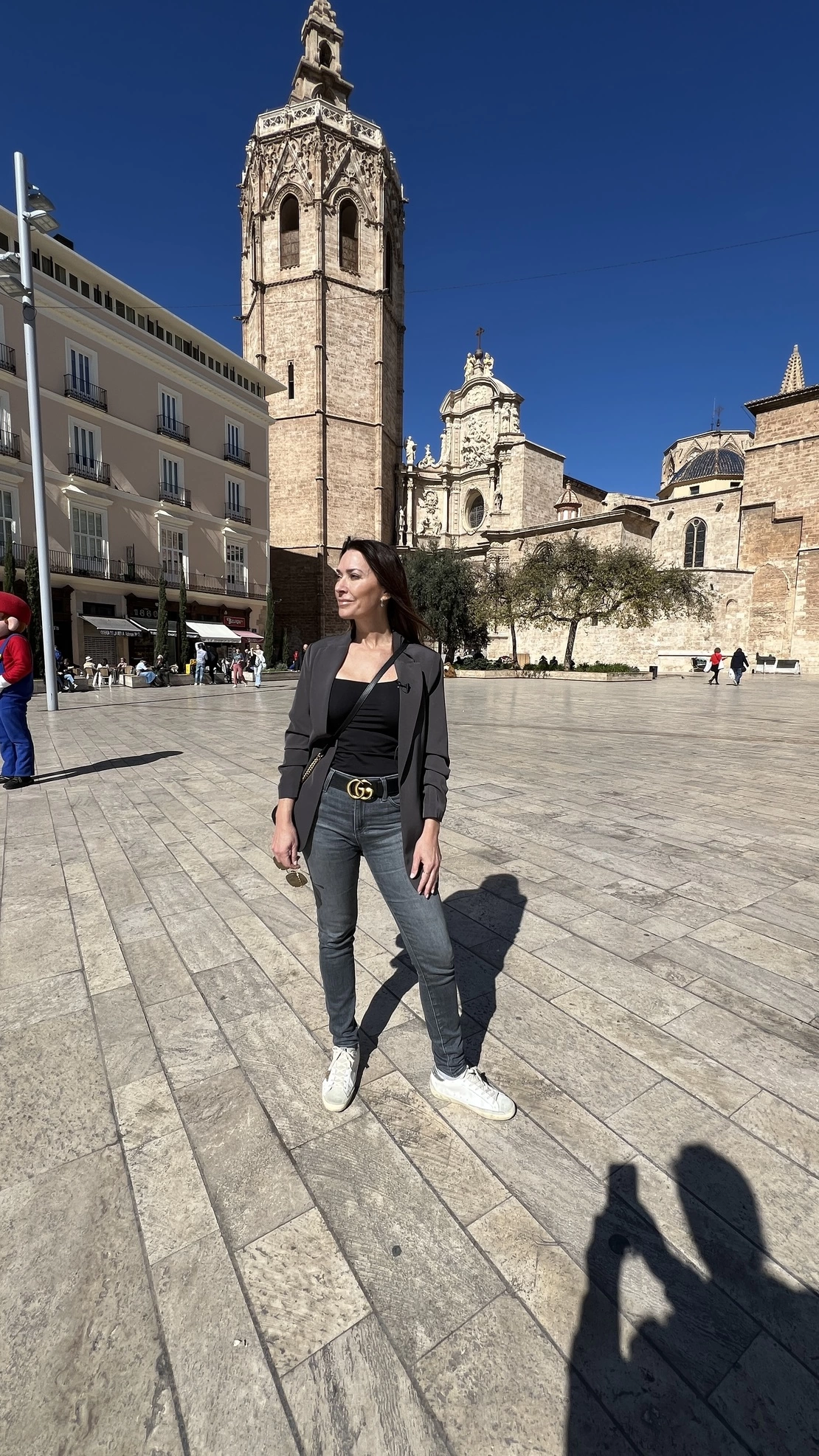 Karen standing in a old town square plaza.
