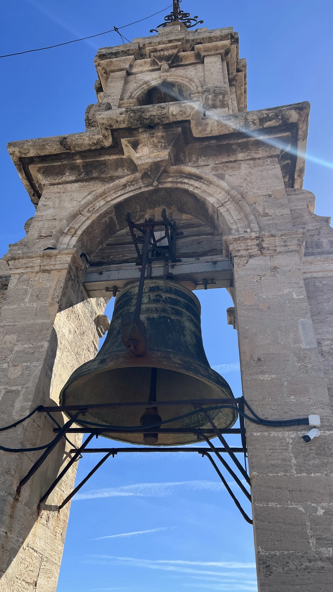 a large bell on a stone tower