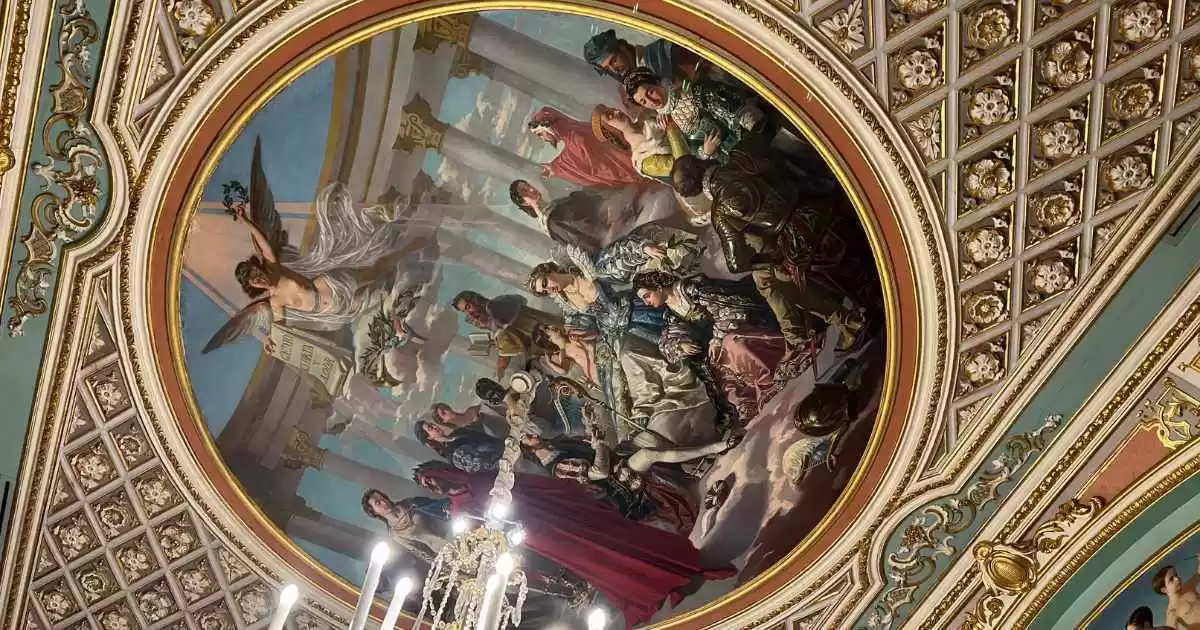 a mural painting of owners on the ceiling of a building