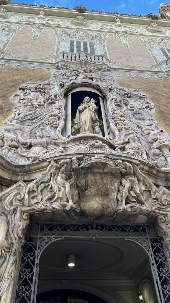 Alabaster facade statue on a building entrance