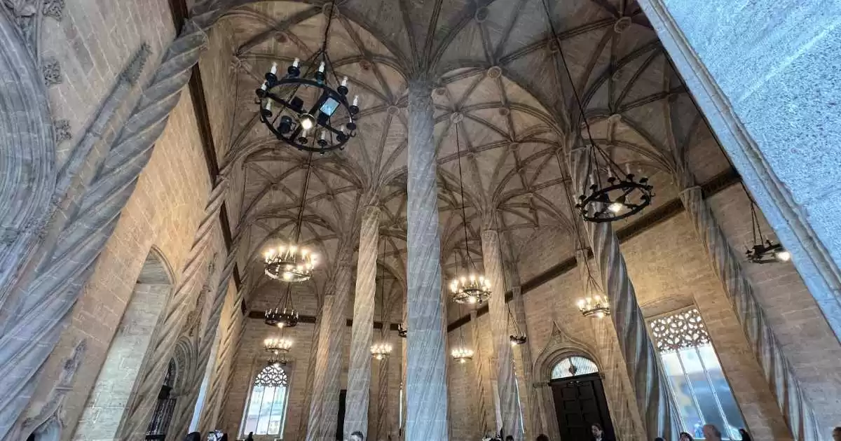 a large stone building with columns and chandeliers