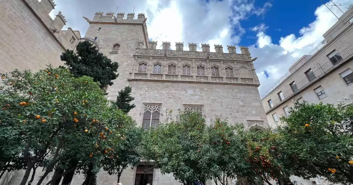Silk Exchange building with trees and a blue sky