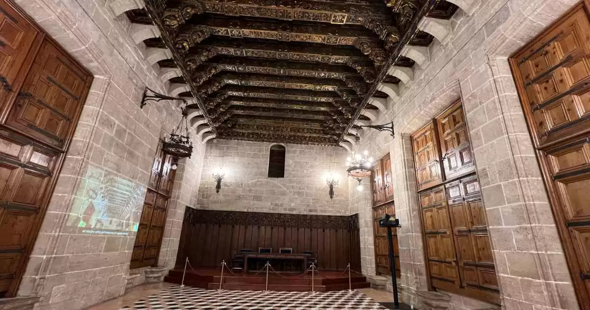 a room with a checkered floor and wooden ceiling