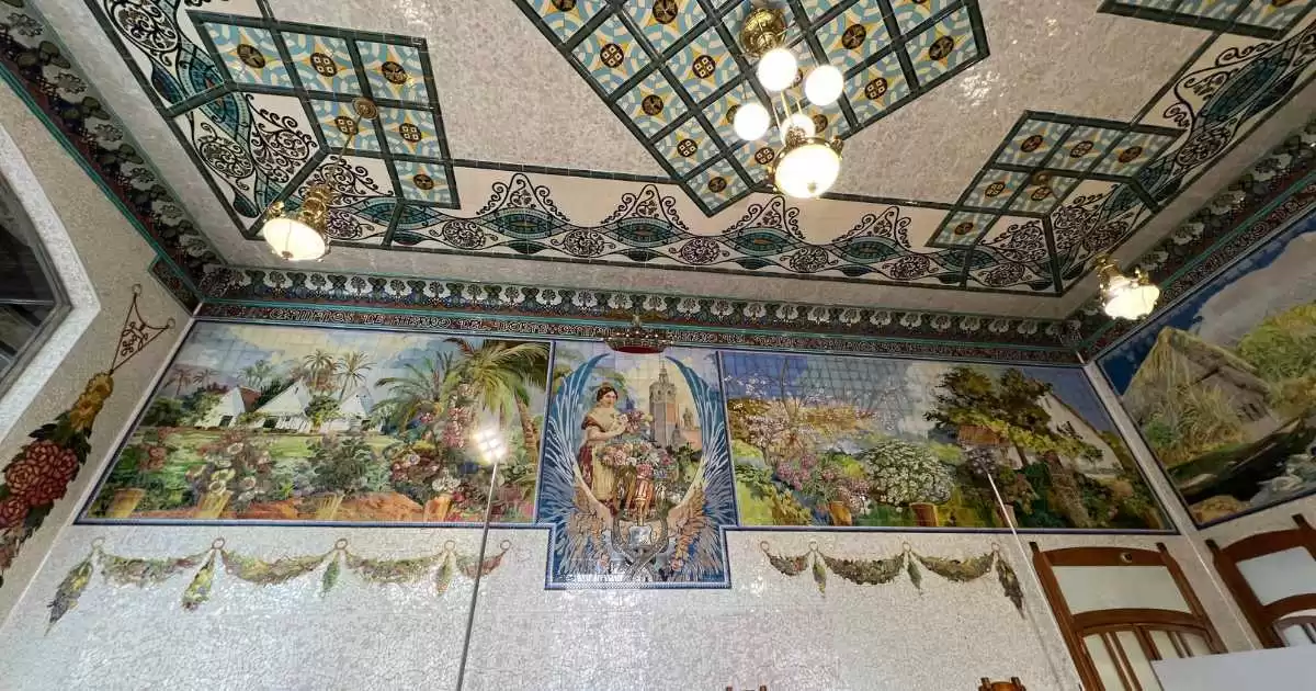 a ceramic ceiling with a tile wall and a painting in Valencia train Station.
