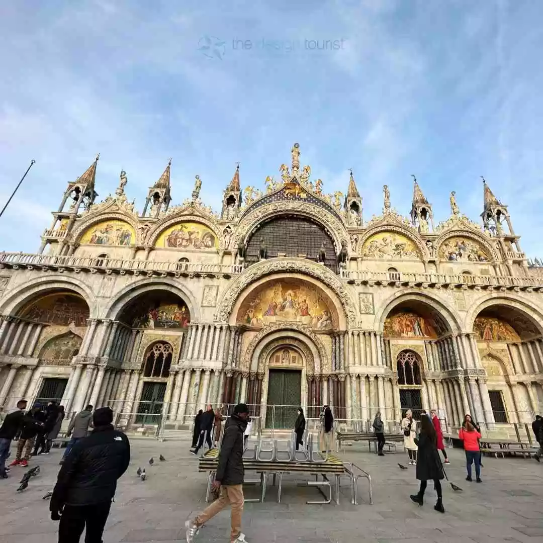 7 Must-Do Activities in Venice, Italy for an Unforgettable Trip Visitors walking in front of the ornate facade of st. mark's basilica in venice.