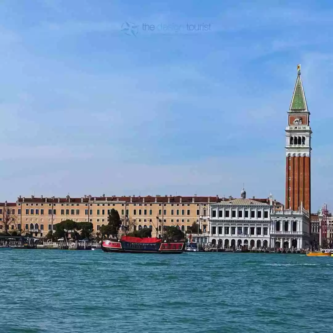 7 Must-Do Activities in Venice, Italy for an Unforgettable Trip A photo of St. Mark's Square in Venice, Italy, with a water taxi in the foreground, the clock tower (Campanile di San Marco) in the center, and St. Mark's Basilica (Basilica di San Marco) on the right. There are many other buildings and people in the square.