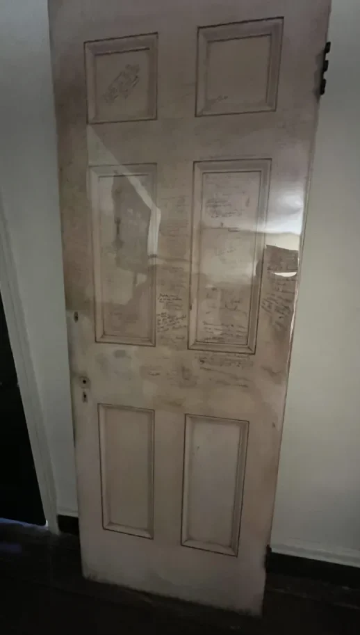 A door that has some signatures on it