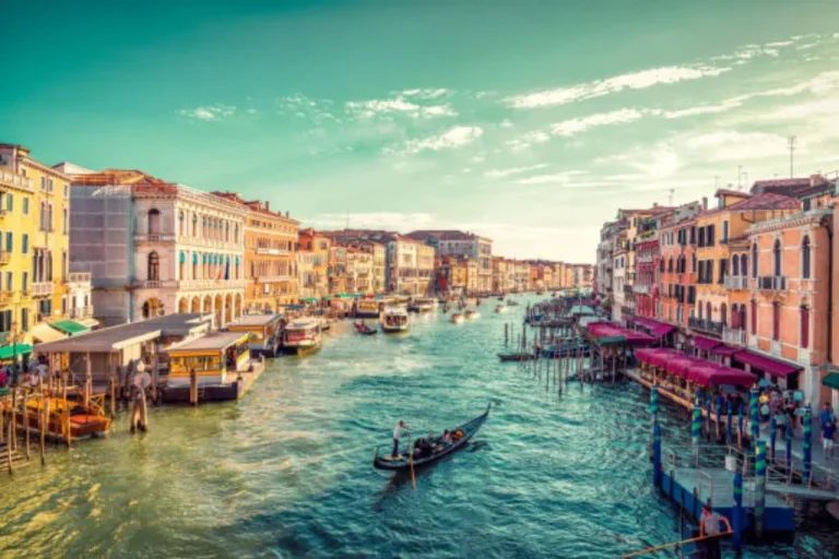 a Venice canal with a few boats in it
