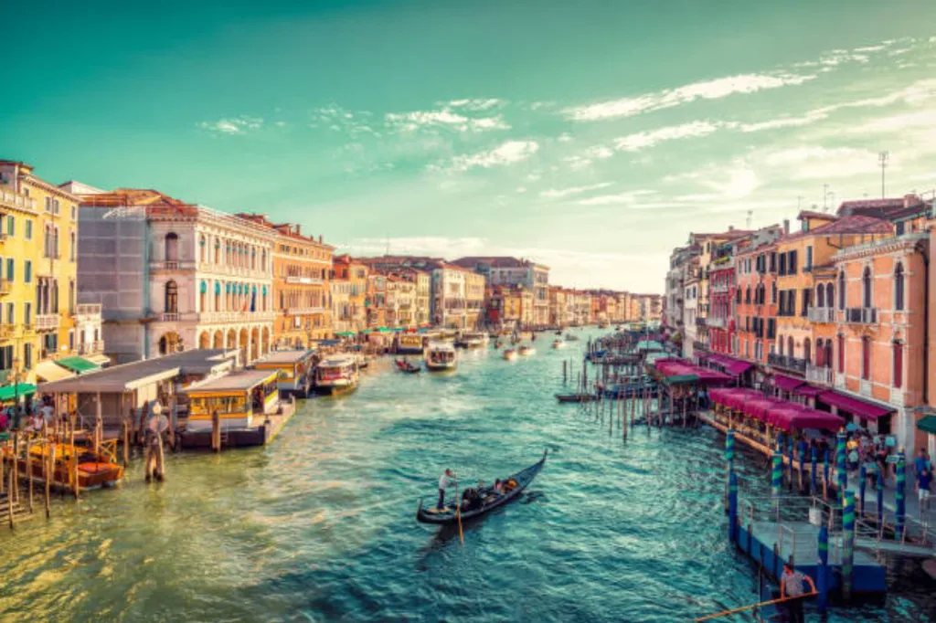 a Venice canal with a few boats in it