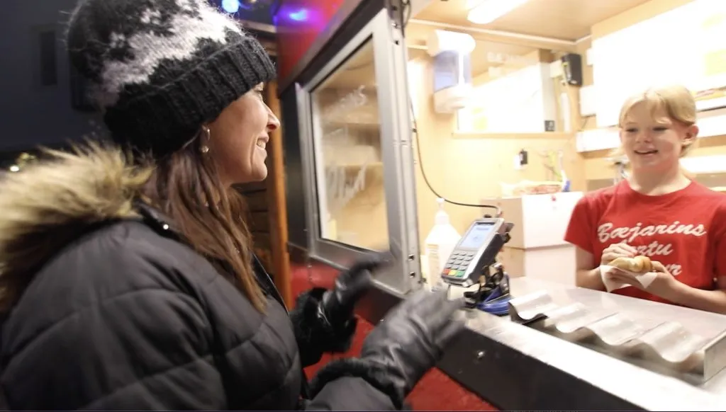 Karen buying famous hotdog in Reykjavik Iceland.
