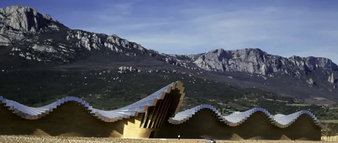 the Bodegas Ysios Winery long undulating structure overlooks the Sierra de Cantabria mountain range.