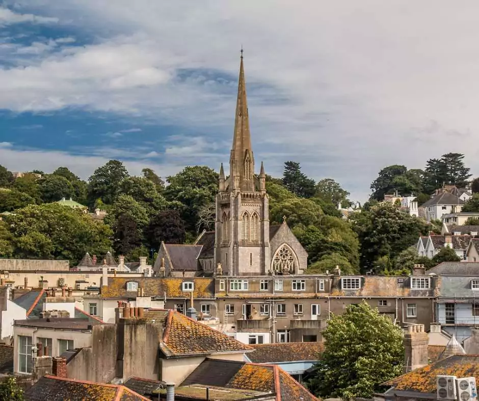 A view of a city with a steeple in the background, one of the historic cities in England.