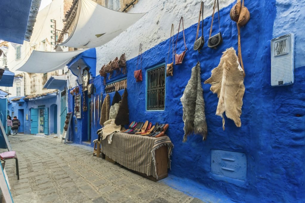 What to Visit in Morocco? Top Must-Visit Spots Morocco, Chefchaouen, Souvenirs for sale at traditional blue buildings