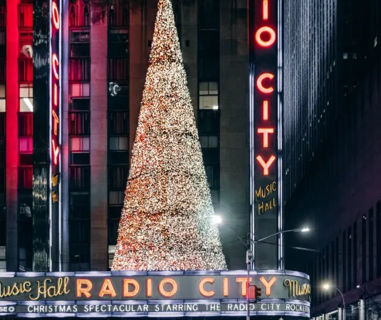 the radio city christmas tree in front of radio city music hall