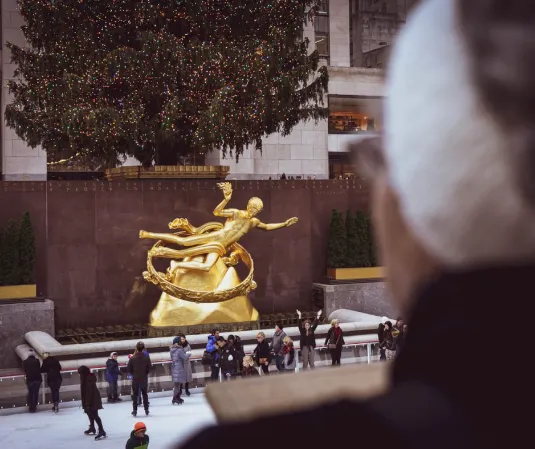 a group of people standing in front of a golden statue