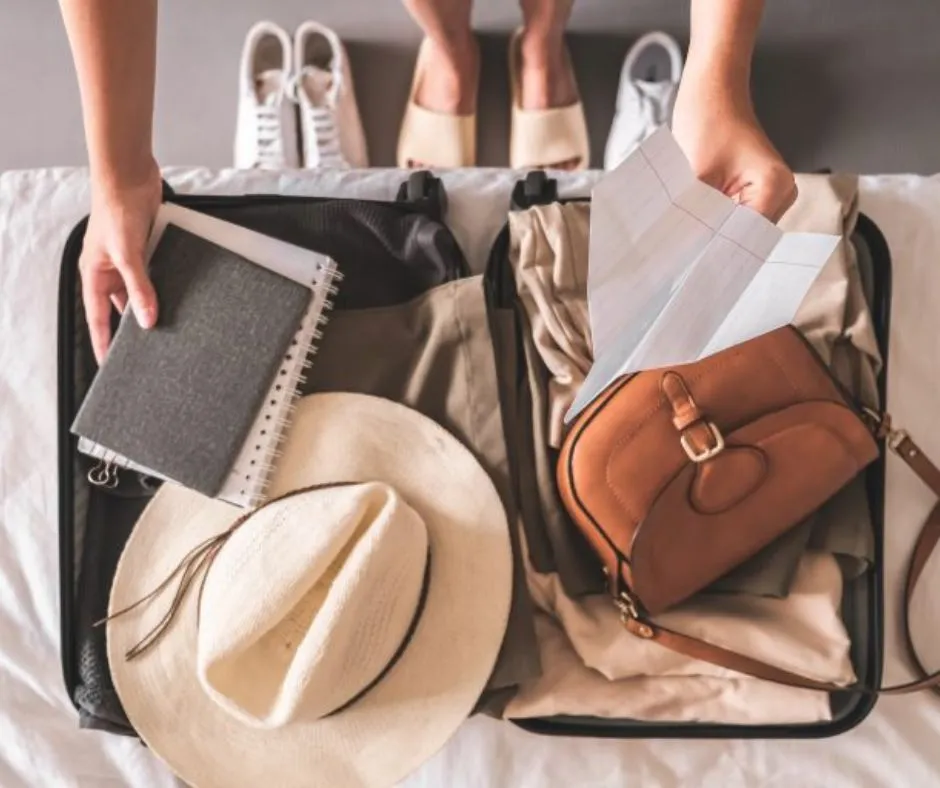 a person standing on top of a suitcase filled with luggage