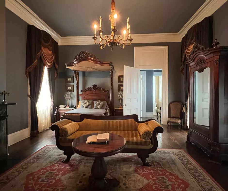 a room with a bed and a couch of Nottoway Mansion