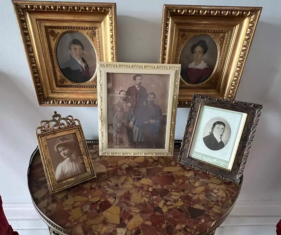 a group of framed pictures on a table of Nottoway Mansion