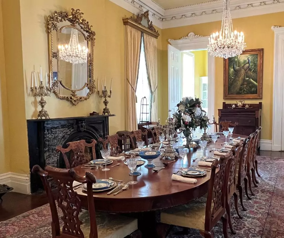a dining room with a large table set with plates and glasses