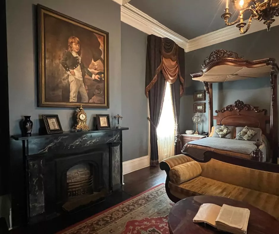 a room with a fireplace and a bed of Nottoway Mansion