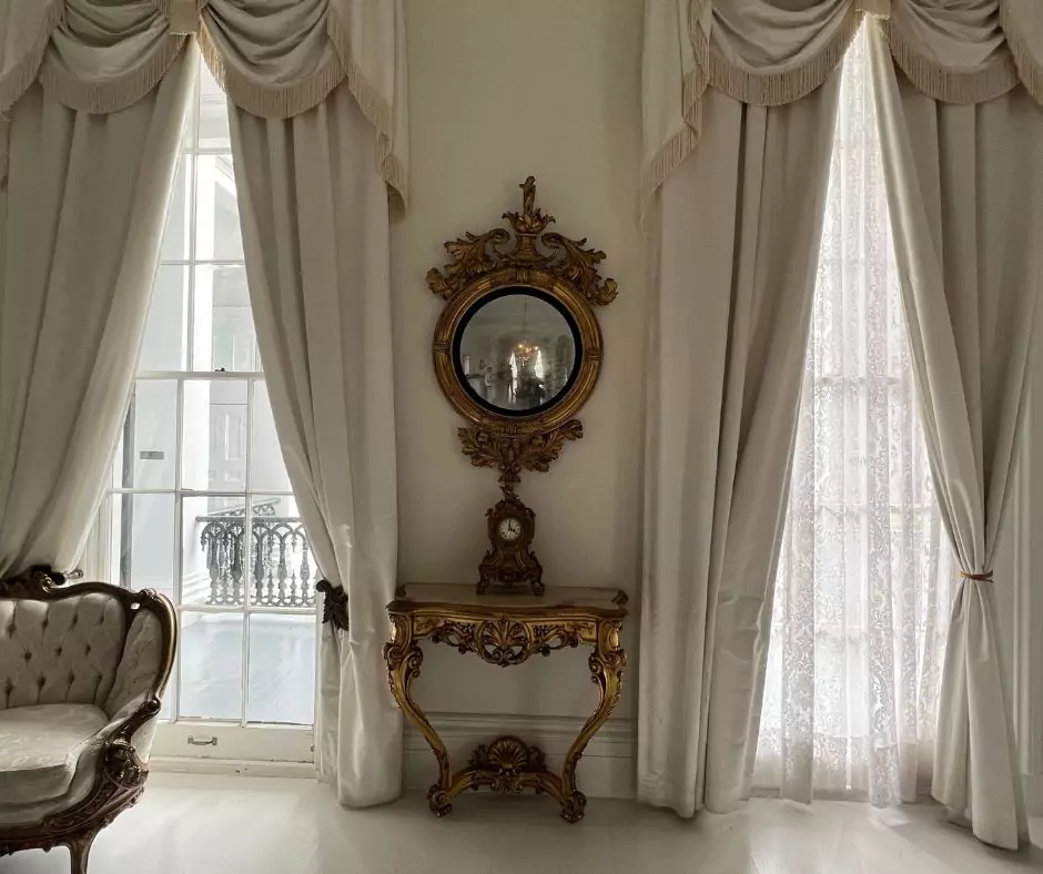 a room with a mirror and a chair of Nottoway Mansion