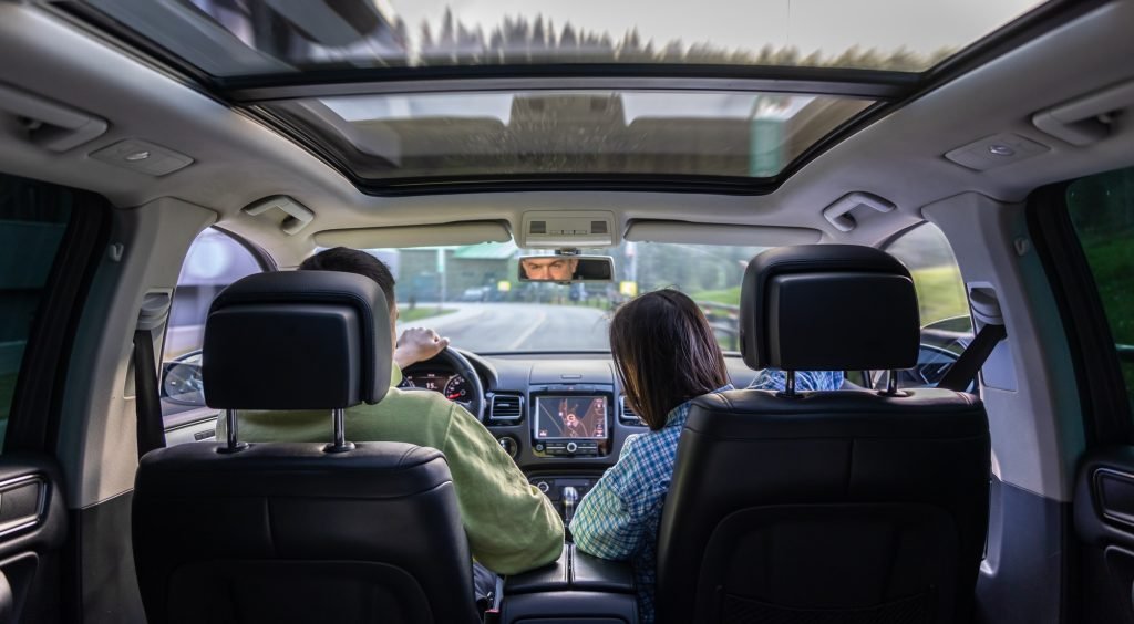Man and woman traveling in car, sitting in car driving to travel destination.