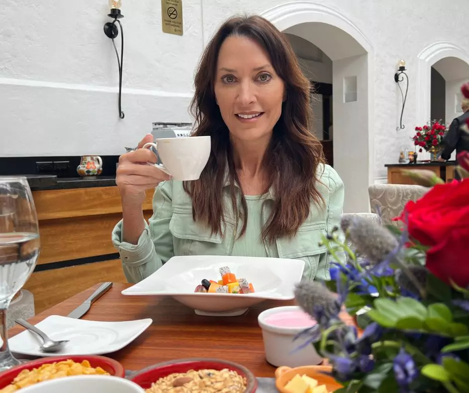 Karen holding a white tea cup in Hotel Mama Cuchara by Art Hotels