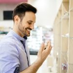 Handsome man buying fragrances