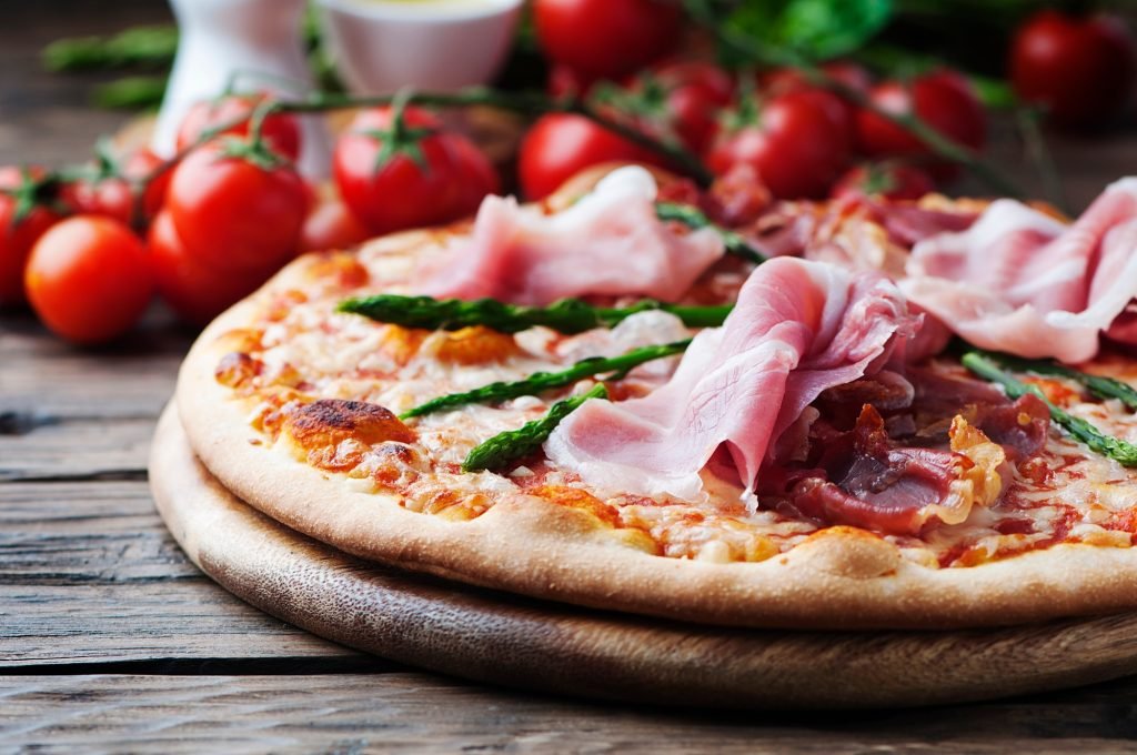 Italian pizza with ham and asparagus