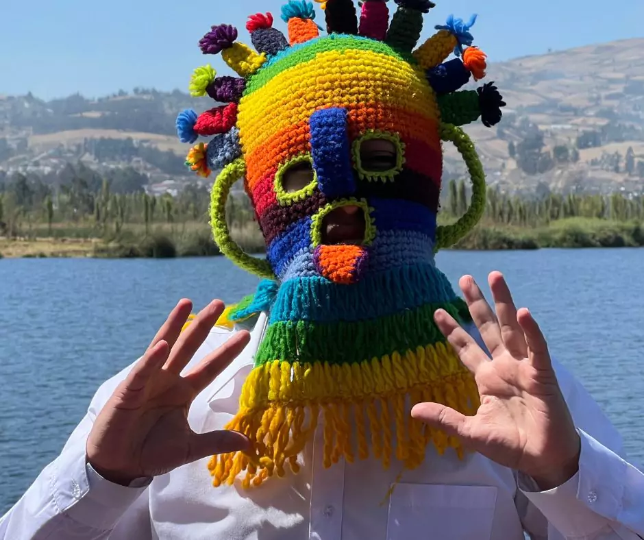 a man wearing a colorful knitted mask known as Aya Huma