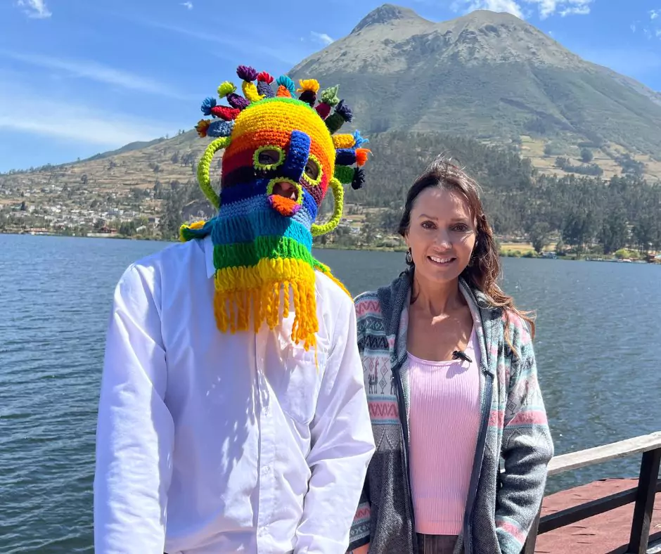 a man wearing Aya Huma mask and woman standing next to a lake