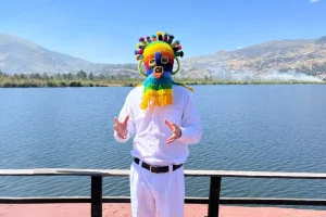 a man wearing a colorful Aya Huma mask
