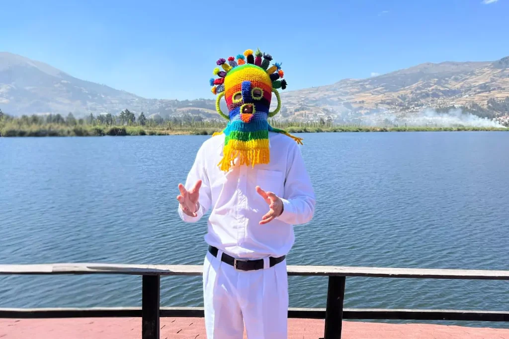 a man wearing a colorful Aya Huma mask