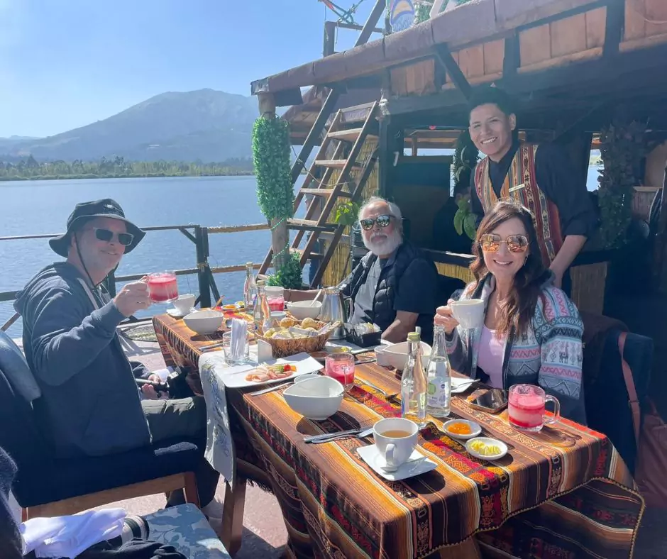 a group of people enjoying a meal on a boat in ecuador