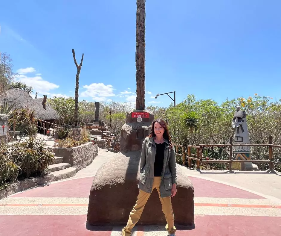 A woman at equator line in ecuador in a sunny day.